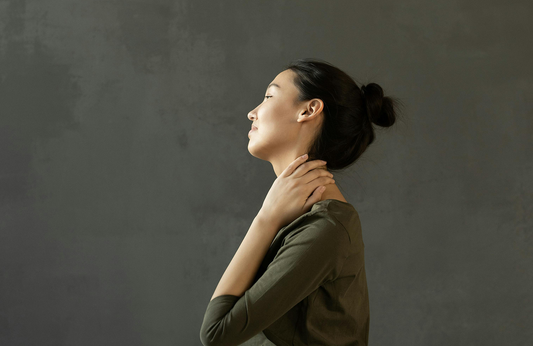 woman holding neck for pain relief